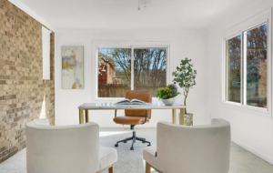 A home office with a brown leather chair