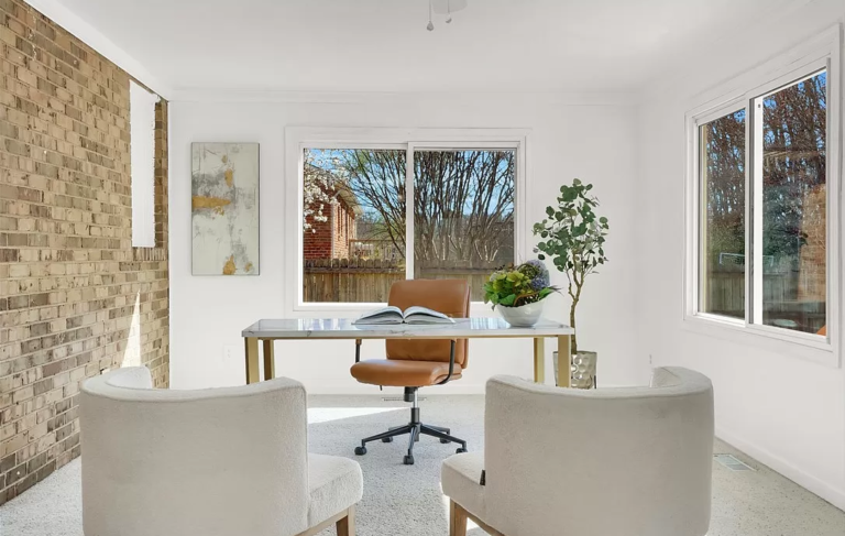A home office with a brown leather chair