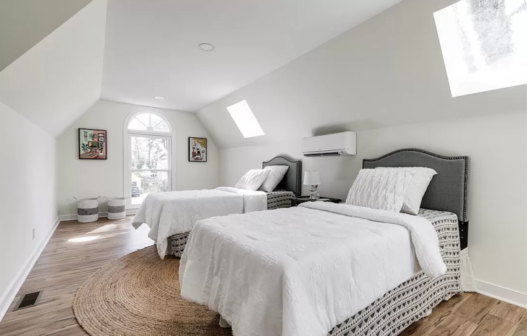 A bedroom with two single beds